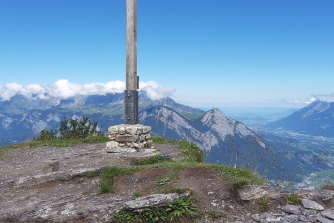 Garmil summit cross with a view of the Churfirsten