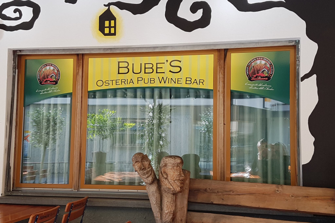 The facade of Bube's Pub with one of the artworks on its porch.