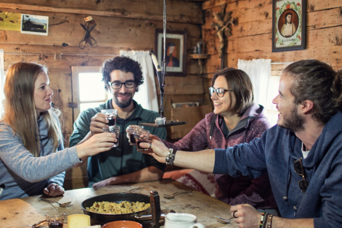 Eine Gruppe beim Essen in der Tegia Rasuz.