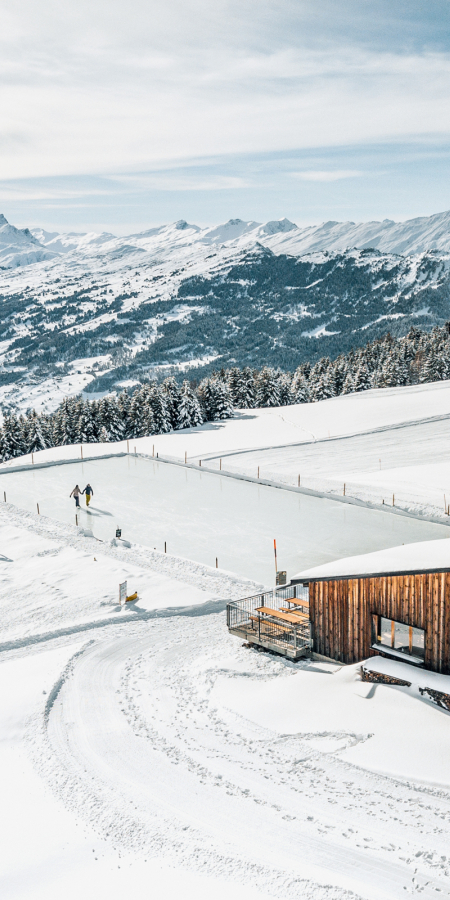 A couple enjoy the view on the Alp Raguta natural ice field