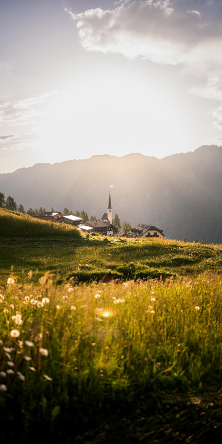 Blick auf das Bergdorf Tenna im Safiental bei Sonnenuntergang