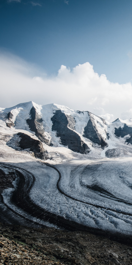 The curved Pers Glacier and the peaks of the Bernina Group in the sunlight