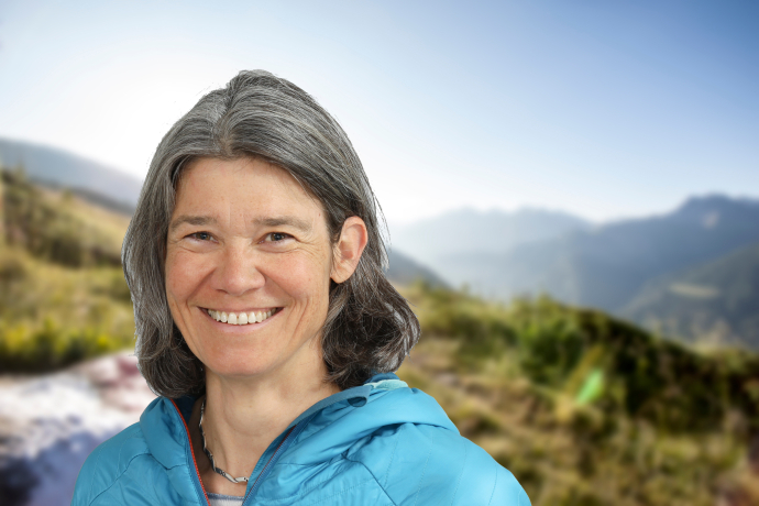Porträt von Wanderleiterin Anita Gschwind vor Berglandschaft