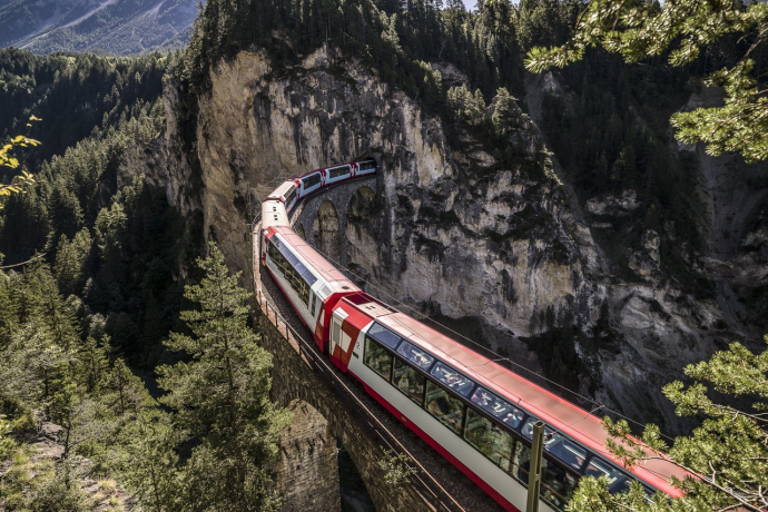 Il viadotto di Landwasser, lungo 142 metri e alto 65 metri, conduce in una curva stretta sopra la selvaggia valle di Landwasser e direttamente in una galleria (Foto: © Graubünden Ferien / Andrea Badrutt) Il Glacier Express attraversa il viadotto di Landwasser