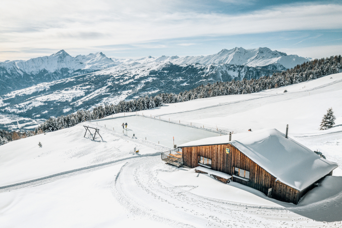A couple enjoy the view on the Alp Raguta natural ice field