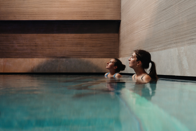 Das wellnessHostel3000 in Laax vereint moderne Jugendherberge mit stilvollem Spa-Angebot (Foto: © Schweiz Tourismus / Lorenz Richard) Zwei Frauen entspannen im Hallenbad des wellnessHostel3000 in Laax