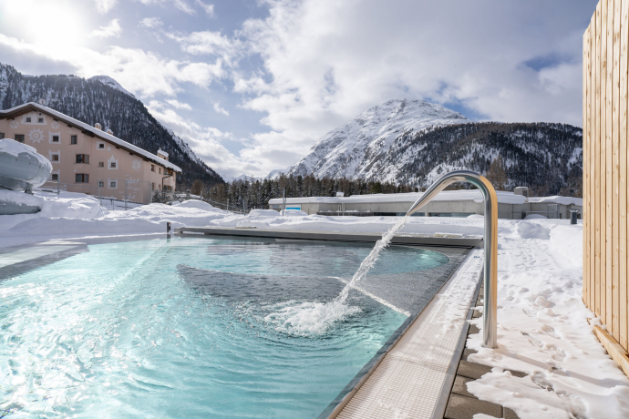 Bellavita Pontresina in winter with heated pool and mountain panorama under a blanket of snow