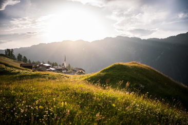 View of the mountain village of Tenna in the Safiental valley at sunset