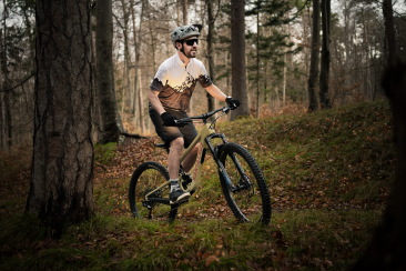 Mountainbiker im Wald mit dem Bikeshirt «Home of Trails»